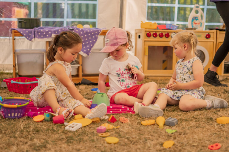 Children playing on floor in marquee