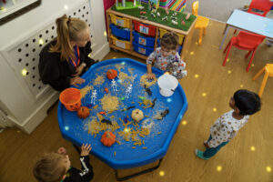 Children playing with pasta shapes