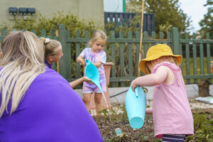 Children watering the vegetable garden