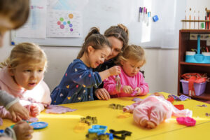 Children playing around a yellow table